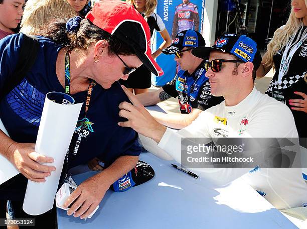Will Davison who drives the Ford's Pepsi Max Crew Ford signs a fan's shirt before qualifying for the Townsville 400, which is round seven of the V8...
