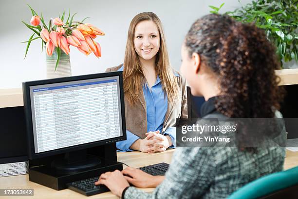 black bank teller with computer, serving banking customer at counter - bank counter stock pictures, royalty-free photos & images