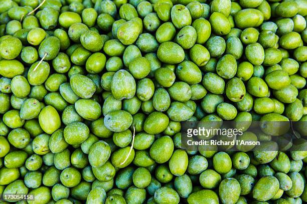 green olives displayed on stall at ballaro market - green olive fruit stock pictures, royalty-free photos & images