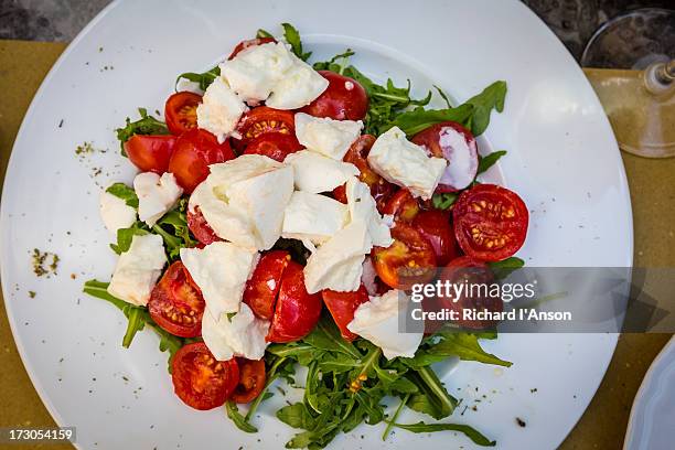 caprese salad on cafe table - caprese salad stock pictures, royalty-free photos & images