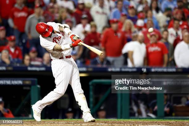 Nick Castellanos of the Philadelphia Phillies hits a solo home run against the Atlanta Braves during the eighth inning in Game Three of the Division...