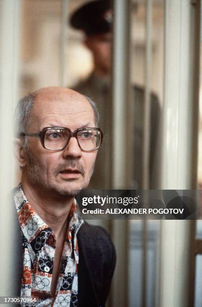 Andrei Chikatilo, accused of murdering at least 55 people in particularly cruel manner, is seen in his special cage in the court in Rostov, during...