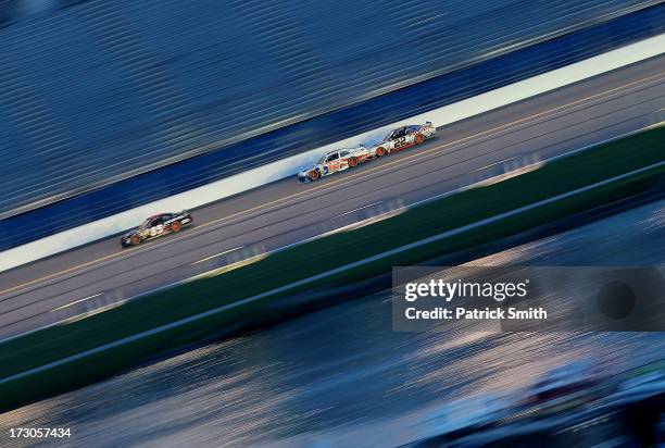 Bobby Gerhart, driver of the Lucas Oil Chevrolet, Sam Hornish Jr., driver of the PPG Ford, and Joey Logano , driver of the Discount Tire Ford, race...