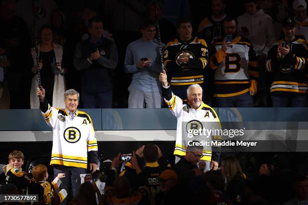 Former Boston Bruins Bobby Orr and Phil Esposito acknowledge the crowd ahead of the Bruins home opener to their 100th Season at TD Garden on October...