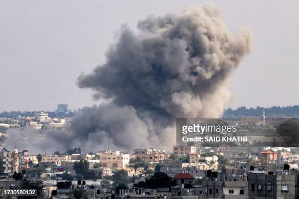Smoke plumes billow after an explosion during Israeli bombardment in Rafah in the southern Gaza Strip on October 18, 2023. A blast ripped through a...