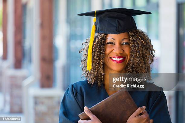 happy graduate - black gown stock pictures, royalty-free photos & images