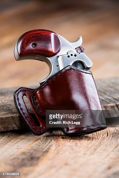 handgun on wood background - holster stock pictures, royalty-free photos & images
