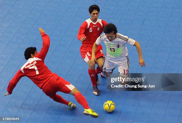 Kazuhiro Nibuya of Japan compete for the ball with Alireza Vafaei and Ali Asgher Hassan Zadeh Navlighe of Iran during the Men's Futsal Gold Medal...