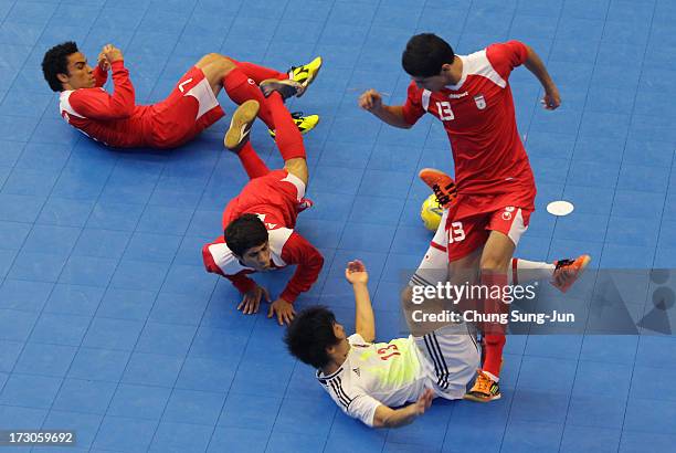 Kazuhiro Nibuya of Japan compete for the ball with Alireza Vafaei and Farhad Tavakoli of Iran during the Men's Futsal Gold Medal match at Songdo...