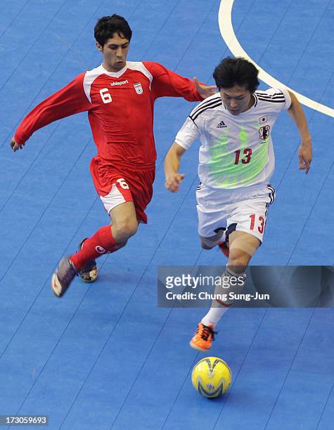 Kazuhiro Nibuya of Japan compete for the ball with Alireza Vafaei during the Men's Futsal Gold Medal match at Songdo Global University Campus...