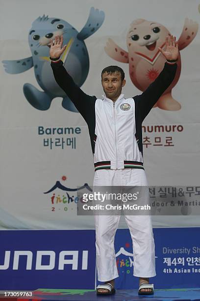 Gold medalist Sobirov Parviz of Tajikistan celebrates on the podium during the victory ceremony for the Kurash Men's +90 kg Final at Ansan Sangnoksu...