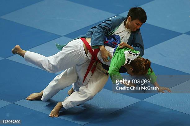 Su Shih Lin of Chinese Taipei throws Bui Thi Hoa of Vietnam during the Kurash Women's -63 kg Semi-Final at Ansan Sangnoksu Gymnasium on July 6, 2013...