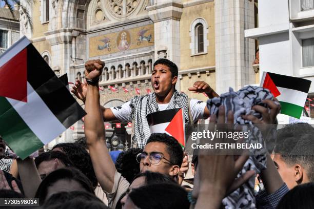 Protesters chant slogans as they gather for an anti-Israel demonstration outside the French embassy headquarters along the Avenue Habib Bourguiba in...