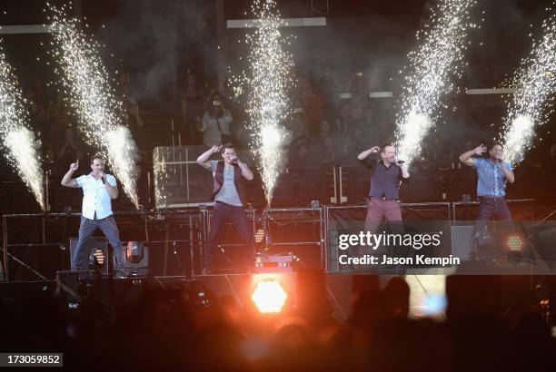 Drew Lachey, Nick Lachey, Justin Jeffre and Jeff Timmons of the band 98 Degrees perform at Staples Center on July 5, 2013 in Los Angeles, California.