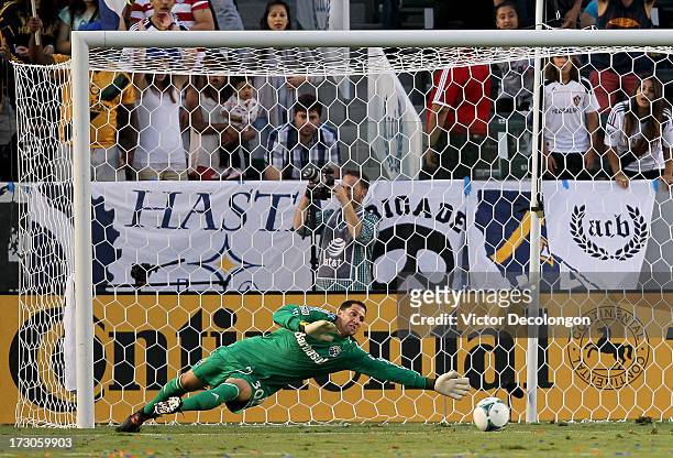 Goalkeeper Andy Gruenebaum of the Columbus Crew dives his left to defend a shot going wide of the net in the first half of their MLS match against...