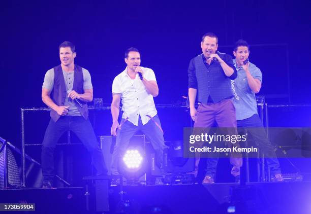 Nick Lachey, Drew Lachey, Justin Jeffre and Jeff Timmons of the band 98 Degrees perform at Staples Center on July 5, 2013 in Los Angeles, California.