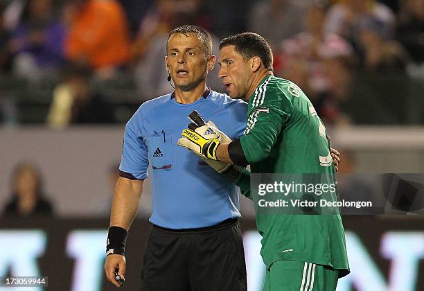 Goalkeeper Andy Gruenebaum of the Columbus Crew argues with referee Sorin Stoica on a foul called in the goal box by Stoica in the second half of the...