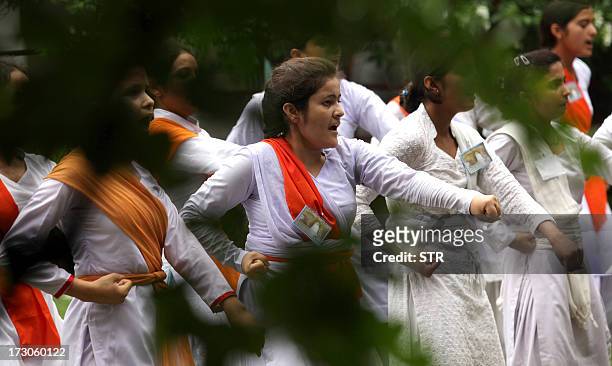Indian Hindu girls of the Durga Vahini, the 'saffron brigade' women's wing of the Hindu hardliner organization Vishwa Hindu Parishad , participate in...