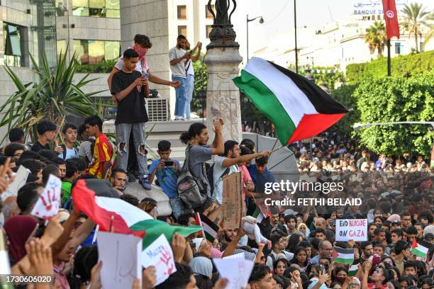 Protesters gather for an anti-Israel demonstration outside the French embassy headquarters along the Avenue Habib Bourguiba in the centre of Tunis on...