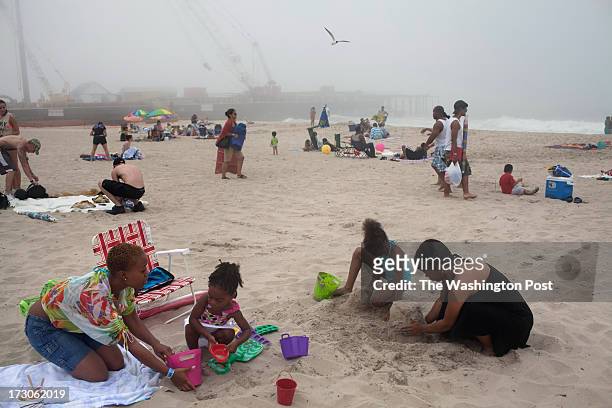Seaside Heights, NJ On a misty morning, Sheryia Scott with her daughters Alyssa Scott Annaela Scott and friend Joya Allen, right, build sandcastles...