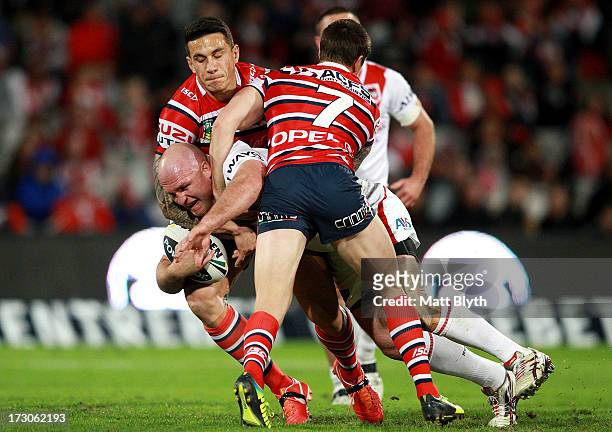 Michael Weyman of the Dragons is tackled during the round 17 NRL match between the St George Illawarra Dragons and the Sydney Roosters at WIN Jubilee...
