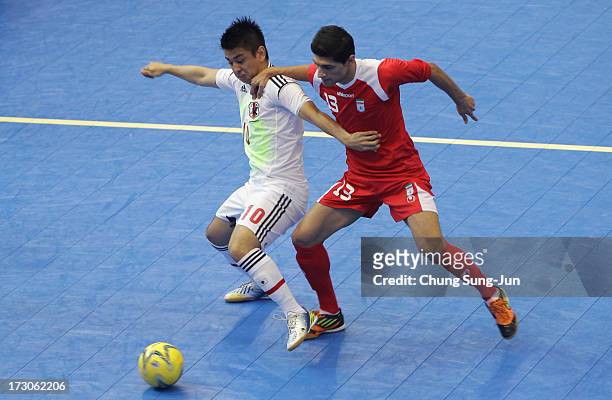 Kazuhiro Nibuya of Iran competes for the ball with Katsutoshi Henmi of Japan during the Men's Futsal Gold Medal match at Songdo Global University...