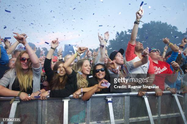 Fans watch Calvin Harris perform on stage on Day 4 of Hove Festival 2013 on July 5, 2013 in Arendal, Norway.