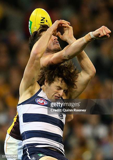 Ben Stratton of the Hawks spoils a mark by Jordan Murdoch of the Cats during the round 15 AFL match between the Geelong Cats and the Hawthorn Hawks...