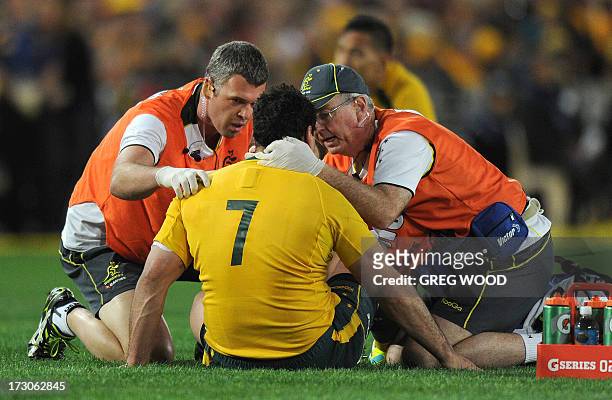 George Smith of Australia is checked by trainers after a heavy clash against the British and Irish Lions during the third and final rugby union Test...