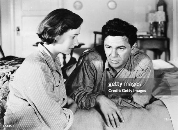 American actors Phyllis Thaxter and John Garfield in a still from the film, 'The Breaking Point,' directed by Michael Curtiz, 1950.