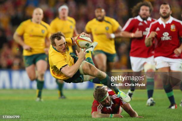 Jesse Mogg of the Wallabies is tackled by Geoff Parling of the British & Irish Lions during the International Test match between the Australian...
