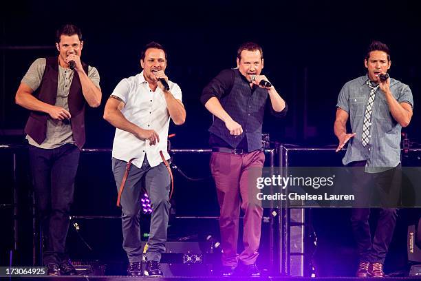 Singers Nick Lachey, Drew Lachey, Justin Jeffre and Jeff Timmons of 98 Degrees perform at Staples Center on July 5, 2013 in Los Angeles, California.