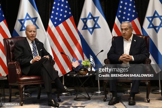 President Joe Biden listens to Israel's Prime Minister Benjamin Netanyahu as he joins a meeting of the Israeli war cabinet in Tel Aviv on October 18...