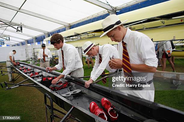 Crew dismantle their boat after losing their race the previous day on day four of the Henley Royal Regatta on July 6, 2013 in Henley-on-Thames,...