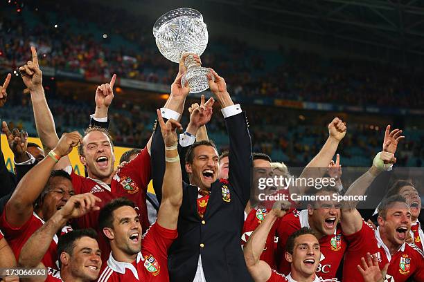 Injured captain Sam Warburton and Lions captain Alun Wyn Jones hold the Tom Richards Cup aloft after the Lions victory in the International Test...