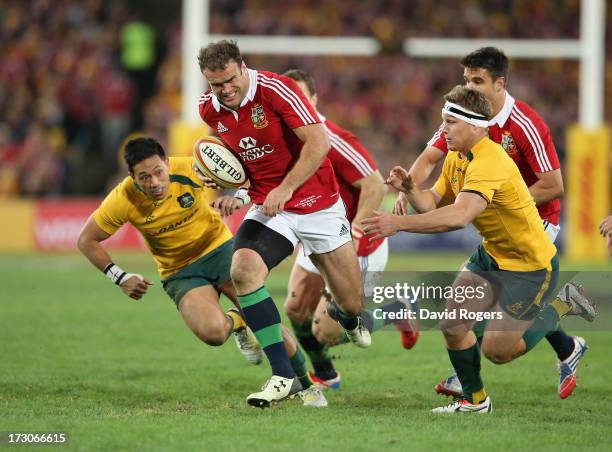 Jamie Roberts of the Lions breaks clear of Christian Leali'ifano and Michael Hooper to score the Lions fourth try during the International Test match...