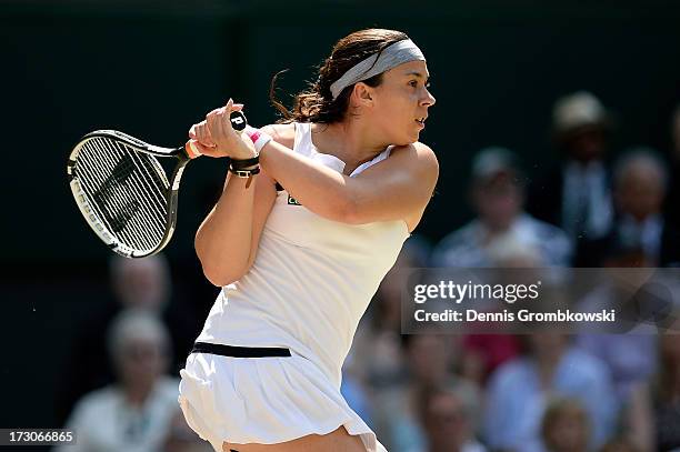 Marion Bartoli of France plays a backhand during the Ladies' Singles final match against Sabine Lisicki of Germany on day twelve of the Wimbledon...