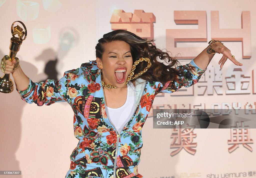 Miss Ko Rapper Taiwanese singer Miss Ko jumps and displays a trophy for... News Photo ...
