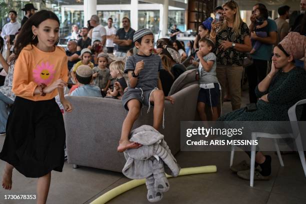 People stay at a hotel in the southern city of Eilat on October 17 which is hosting survivors from the Israeli kibbutz of Nir Oz near the Gaza border...