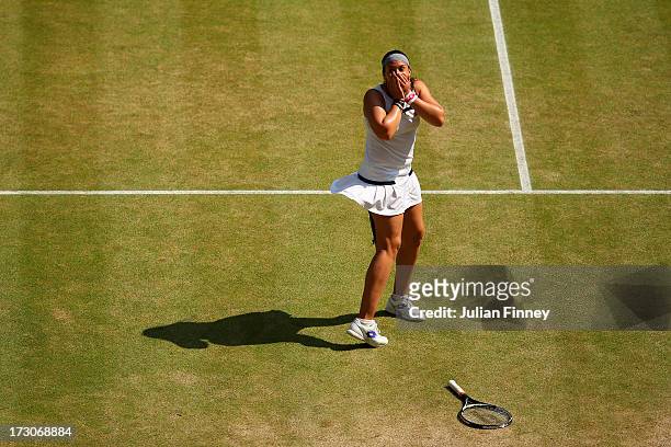 Marion Bartoli of France celebrates championship point during the Ladies' Singles final match against Sabine Lisicki of Germany on day twelve of the...