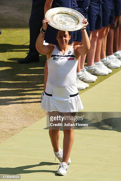 Marion Bartoli of France lifts the Venus Rosewater Dish trophy after her victory in the Ladies' Singles final match against Sabine Lisicki of Germany...