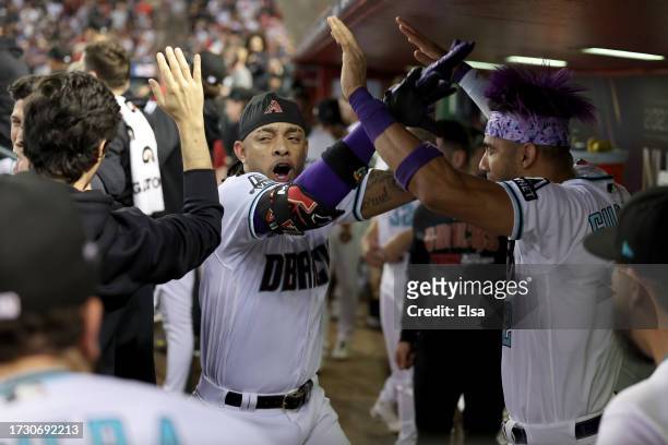 Ketel Marte of the Arizona Diamondbacks celebrates with teammates after hitting a home run in the third inning against the Los Angeles Dodgers during...