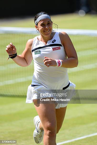 Marion Bartoli of France runs to her box as she celebrates victory after the Ladies' Singles final match against Sabine Lisicki of Germany on day...