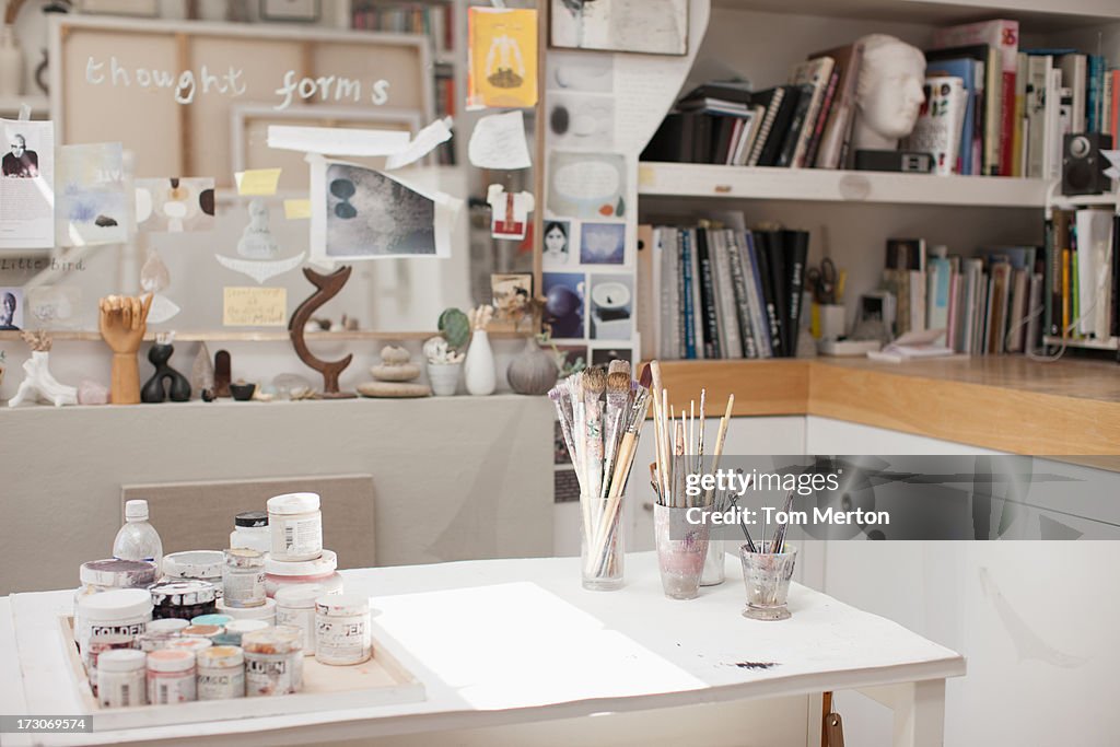 Paintbrushes in jars in art studio