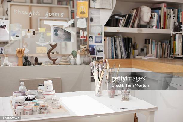 paintbrushes in jars in art studio - art studio stock pictures, royalty-free photos & images