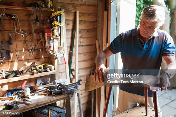 man sanding wood in workshop - shed stock pictures, royalty-free photos & images