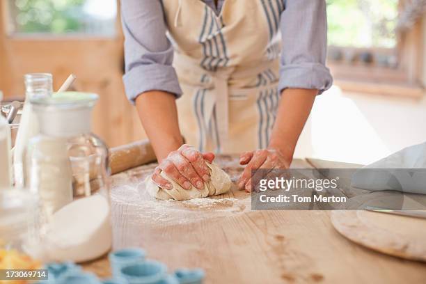 woman kneading dough on kitchen counter - knåda bildbanksfoton och bilder