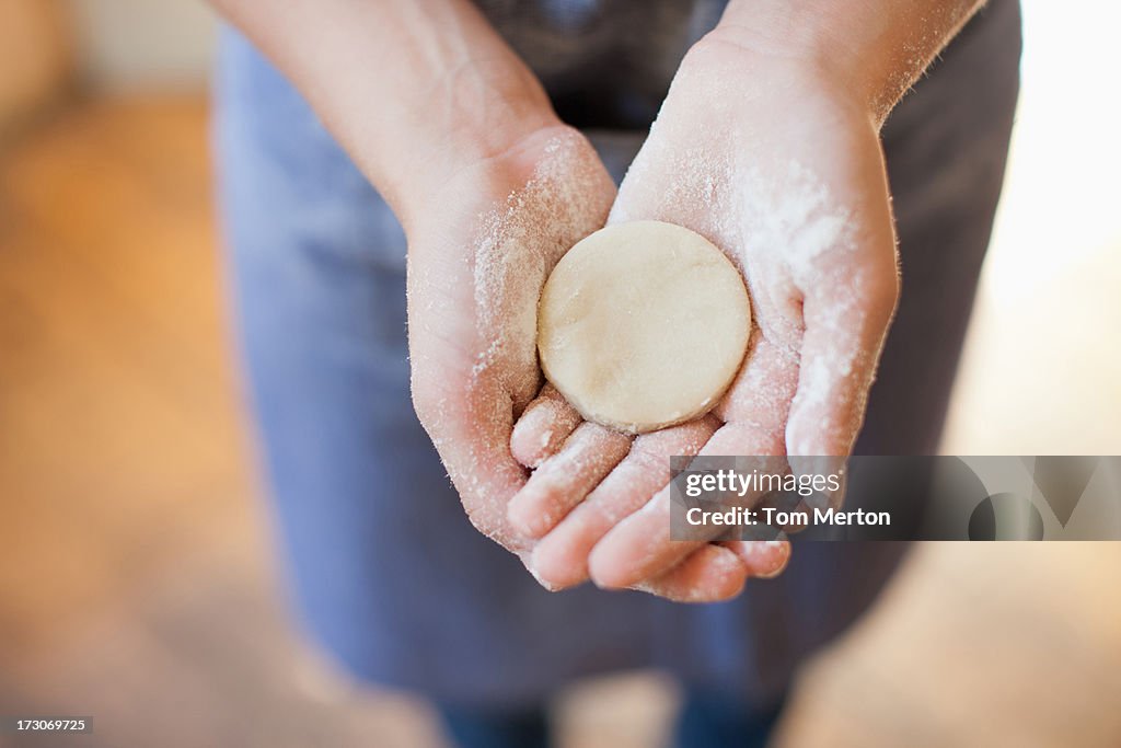 Close up of girl holding round-shape dough