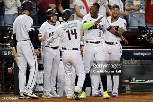 Gabriel Moreno of the Arizona Diamondbacks celebrates with teammates after hitting a home run in the third inning against the Los Angeles Dodgers...