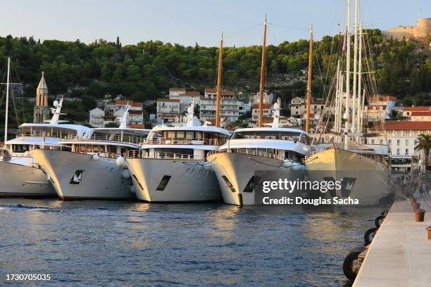 yachts tied up in a line on the dock - celebrity yachts stock pictures, royalty-free photos & images